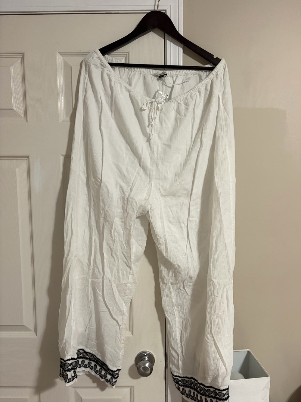 American Eagle White Boho Drawstring Pants with Black Embroidered Hem.